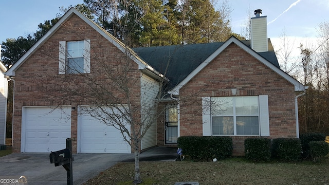 traditional home featuring brick siding, concrete driveway, roof with shingles, a chimney, and a garage