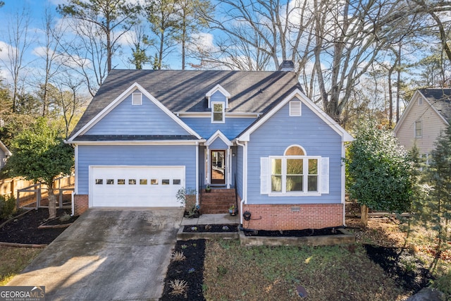 traditional-style house with brick siding, concrete driveway, an attached garage, and fence