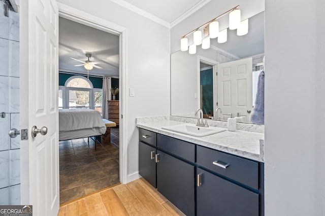 bathroom featuring wood finished floors, connected bathroom, crown molding, ceiling fan, and vanity