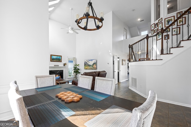 dining room featuring a high end fireplace, visible vents, stairway, and baseboards