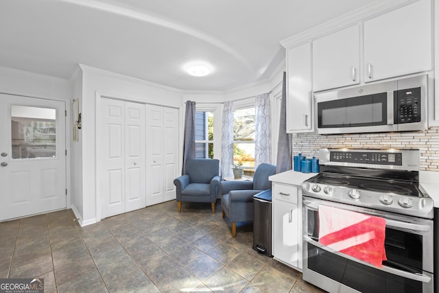 kitchen featuring backsplash, appliances with stainless steel finishes, crown molding, and white cabinetry