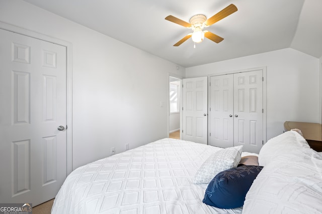 bedroom featuring a closet, lofted ceiling, and a ceiling fan