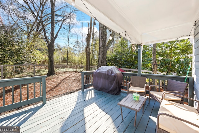 deck featuring a grill and fence