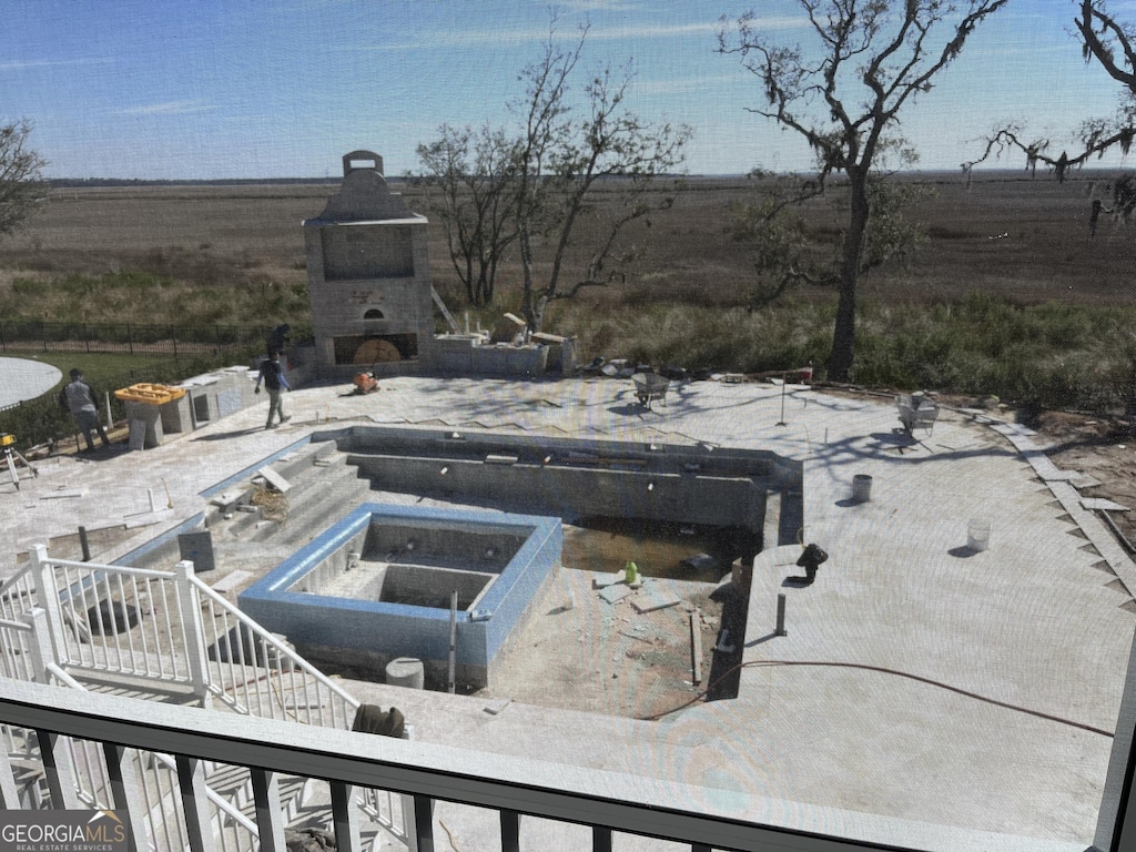 view of swimming pool with an outdoor fireplace and a patio area