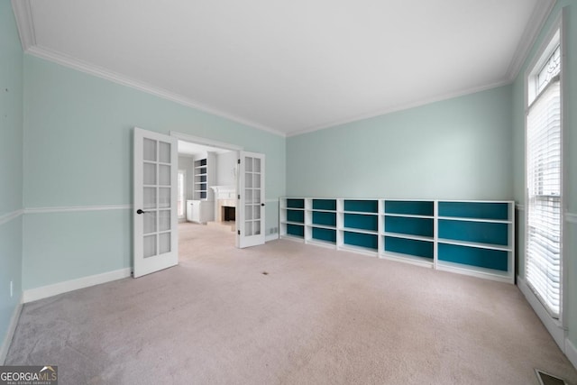 empty room with visible vents, ornamental molding, french doors, carpet, and baseboards