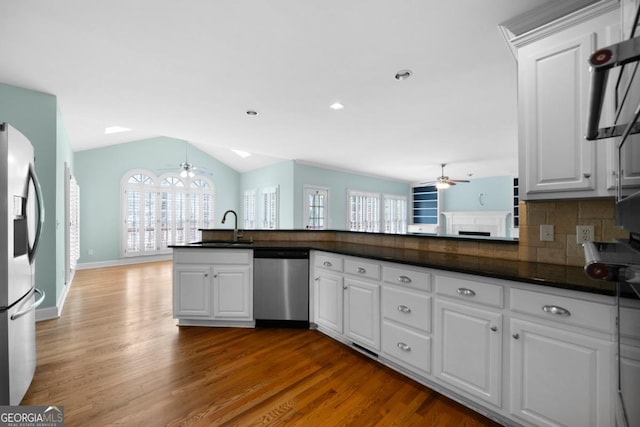 kitchen featuring a sink, dark countertops, appliances with stainless steel finishes, and ceiling fan