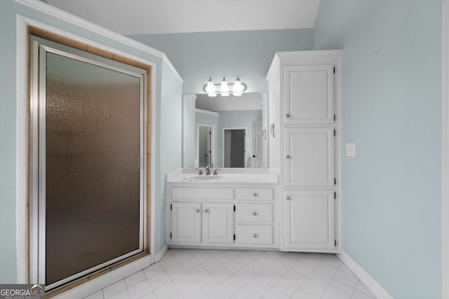 full bathroom with tile patterned flooring, a stall shower, vanity, and baseboards