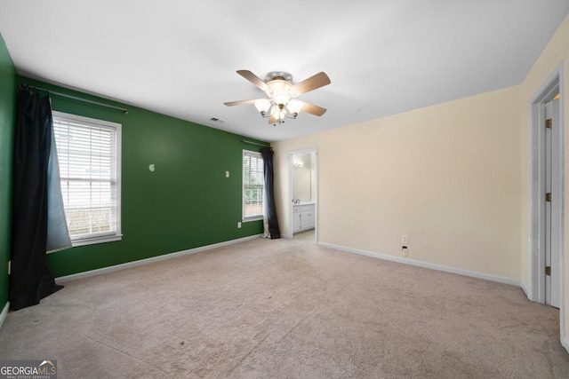 unfurnished bedroom featuring visible vents, baseboards, carpet, and a ceiling fan