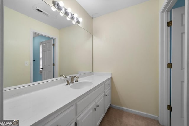 bathroom featuring visible vents, vanity, and baseboards