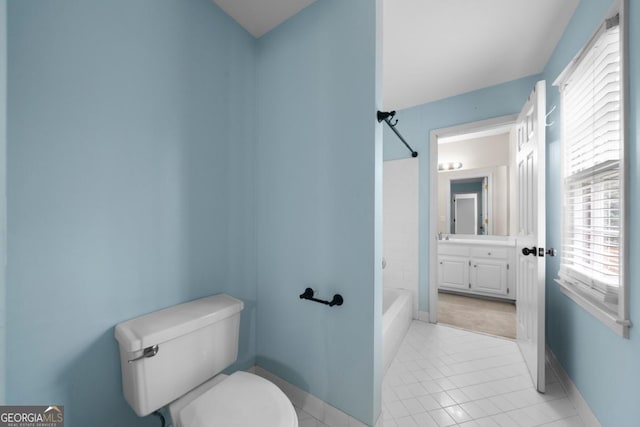 bathroom with tile patterned flooring, baseboards, toilet, shower / tub combination, and vanity