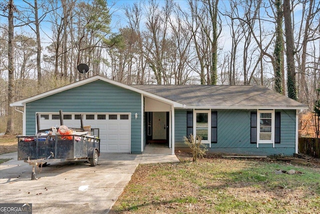 single story home featuring an attached garage and driveway