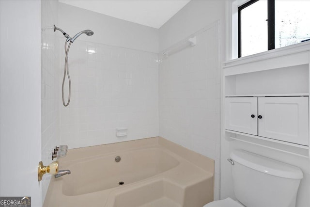 bathroom with tub / shower combination and toilet