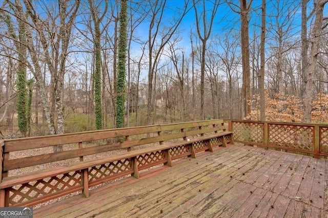 wooden deck with a view of trees