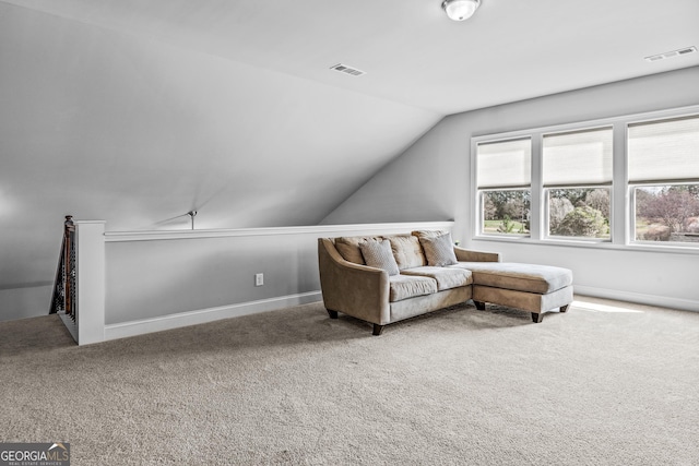 sitting room featuring visible vents, lofted ceiling, and carpet