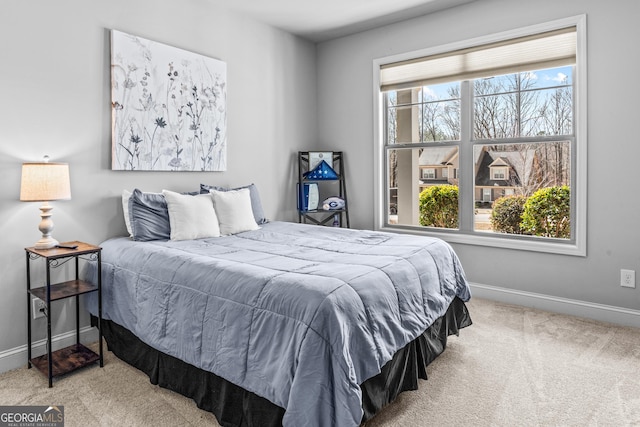 bedroom with baseboards and carpet floors