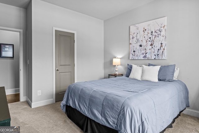 carpeted bedroom featuring baseboards