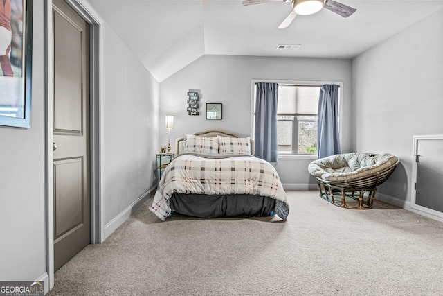 carpeted bedroom featuring visible vents, a ceiling fan, baseboards, and vaulted ceiling