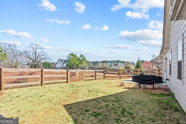 view of yard featuring a rural view and fence