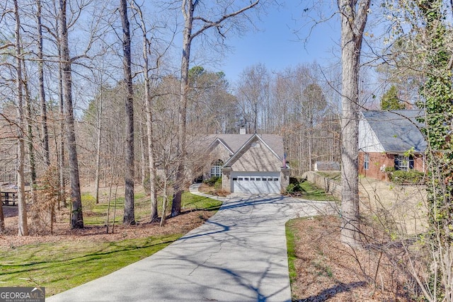 exterior space with aphalt driveway and an attached garage