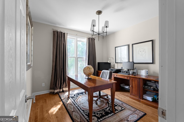 office area with an inviting chandelier, light wood-style floors, and baseboards