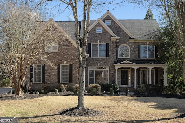 traditional-style house with brick siding and covered porch