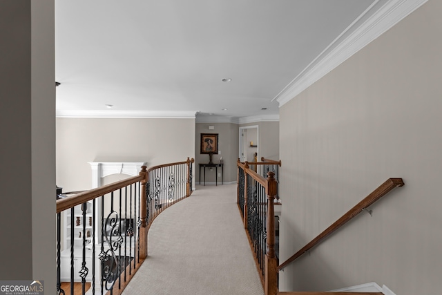 hallway featuring an upstairs landing, ornamental molding, and carpet floors