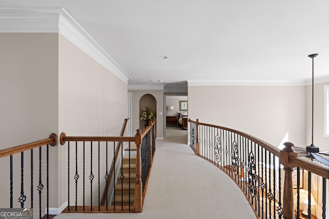 hallway featuring an upstairs landing, light carpet, ornamental molding, recessed lighting, and arched walkways