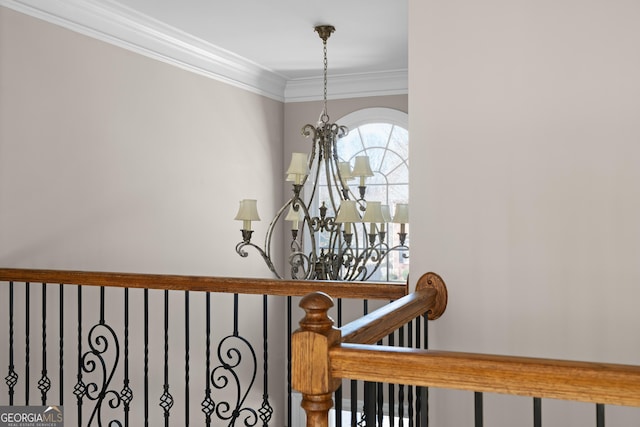 stairway with ornamental molding and a chandelier