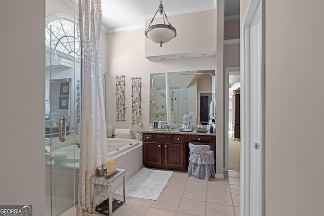 bathroom with a shower stall, tile patterned floors, ornamental molding, a bath, and vanity