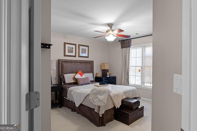 bedroom featuring light colored carpet and ceiling fan