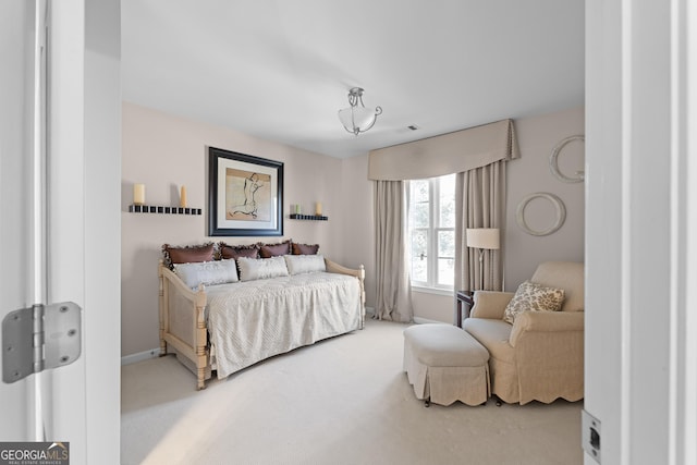 bedroom with visible vents and carpet