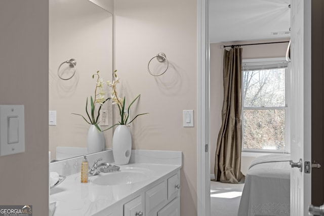 ensuite bathroom with vanity, visible vents, and connected bathroom