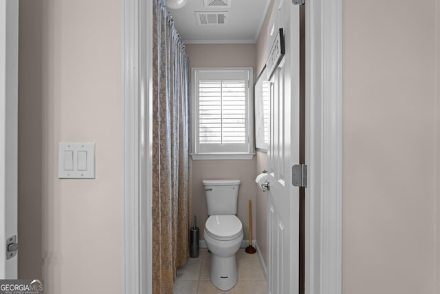 bathroom with tile patterned floors, visible vents, toilet, and crown molding