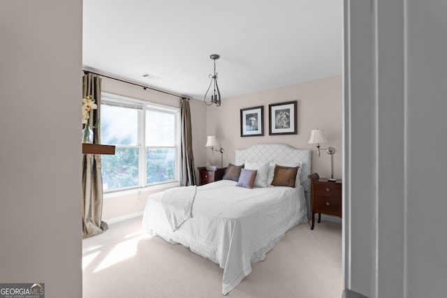 bedroom with light carpet, visible vents, and baseboards