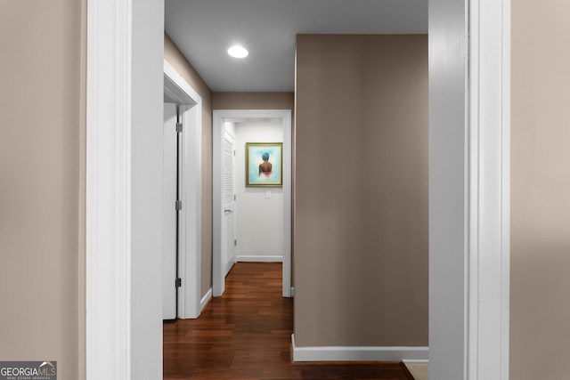 hallway with recessed lighting, baseboards, and dark wood-style flooring