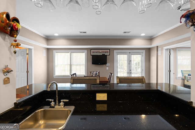 kitchen featuring ornamental molding, french doors, visible vents, and a sink