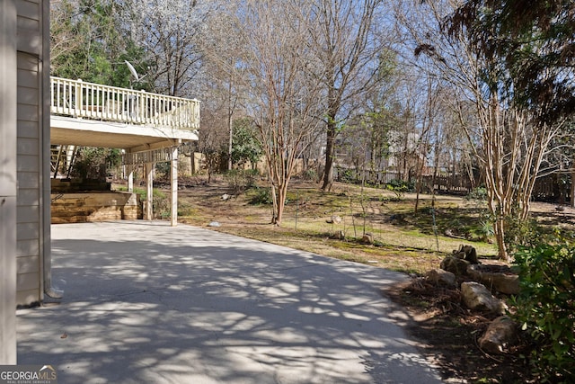 view of patio / terrace featuring stairway, driveway, and a wooden deck