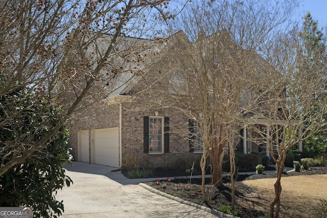 view of front of property with brick siding and concrete driveway