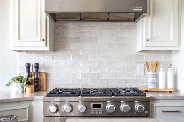 kitchen with white cabinetry, decorative backsplash, wall chimney exhaust hood, and stainless steel gas cooktop