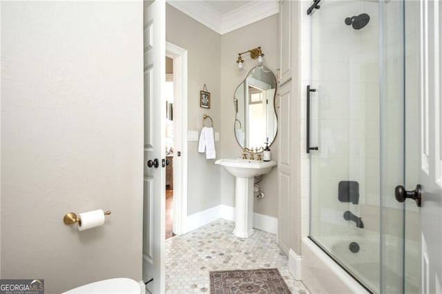 full bathroom with toilet, crown molding, baseboards, and shower / bath combination with glass door