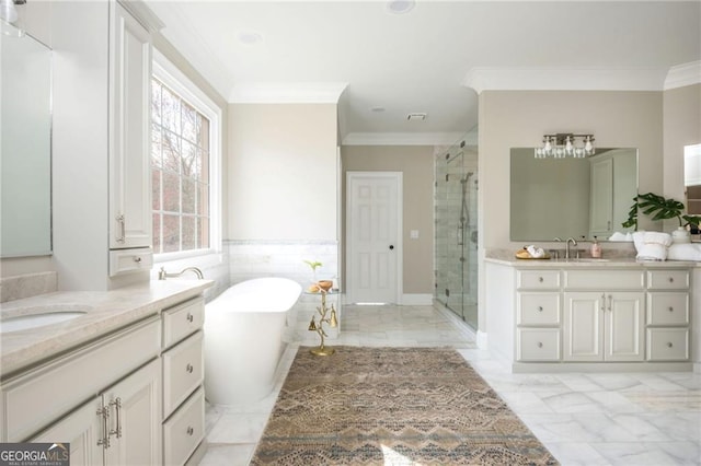 full bathroom with a sink, marble finish floor, a stall shower, and ornamental molding