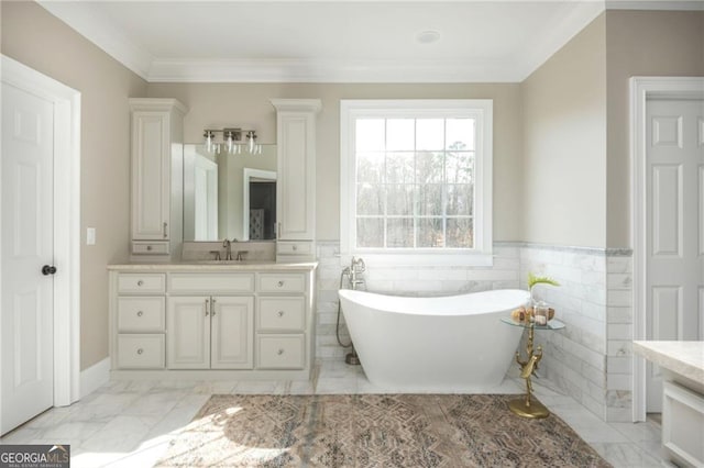 full bathroom with a freestanding bath, marble finish floor, vanity, and crown molding