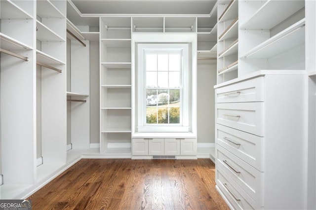 spacious closet with visible vents and dark wood-style flooring