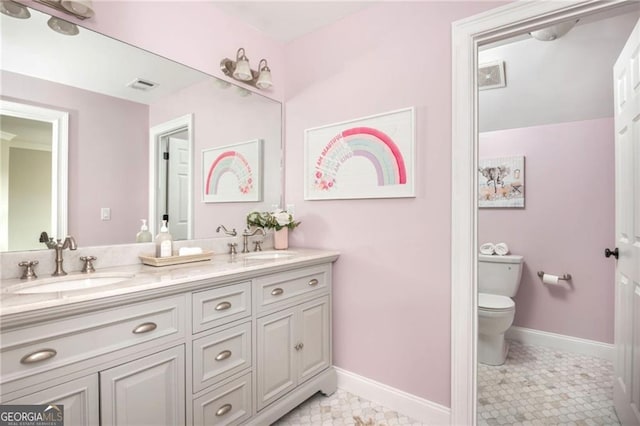 full bathroom with toilet, baseboards, visible vents, and a sink