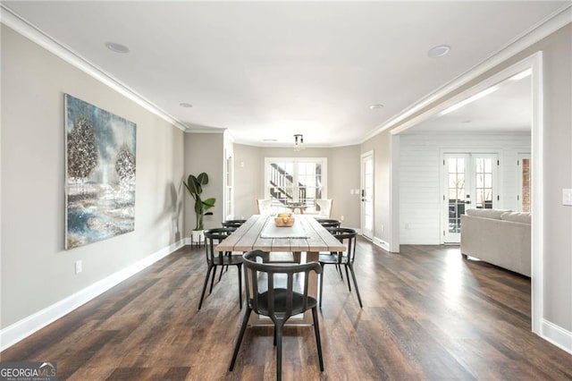 dining area featuring dark wood finished floors, french doors, crown molding, baseboards, and stairs