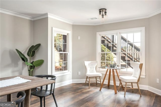 dining area with dark wood finished floors, visible vents, crown molding, and baseboards