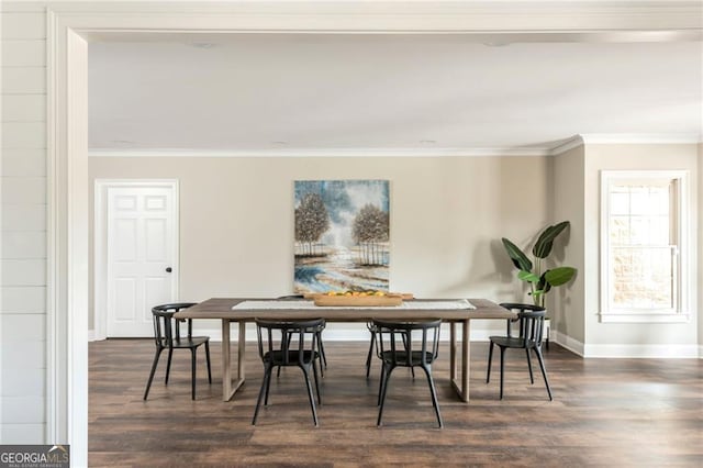 dining room featuring dark wood finished floors, crown molding, and baseboards