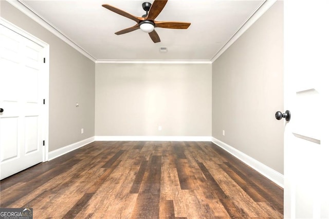 spare room featuring baseboards, wood finished floors, and ornamental molding