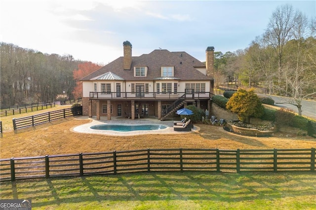 back of property featuring fence, stairway, a wooden deck, a yard, and a patio area