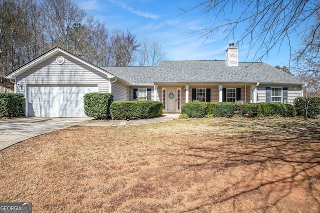 ranch-style home with roof with shingles, an attached garage, a chimney, concrete driveway, and a front lawn